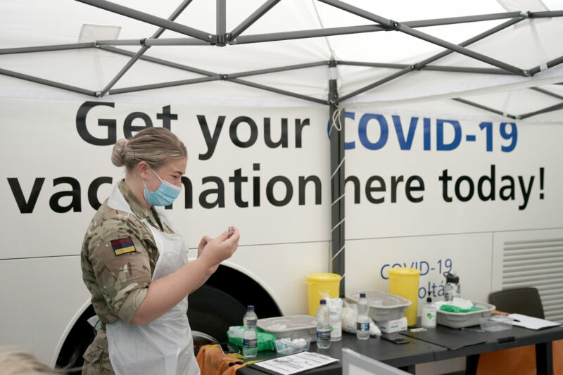 Combat medics from Queen Alexandra's Royal Army Nursing Corps vaccinate members of the public at a rapid vaccination centre, set up outside Bolton Town Hall on June 09, 2021 in Bolton, England. 