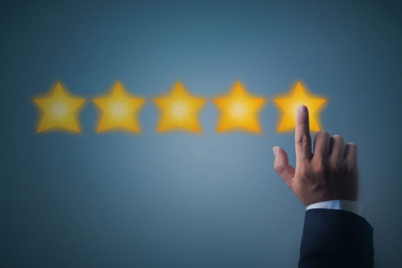 Illustration of five stars and a person's hand to represent a five-star online review.