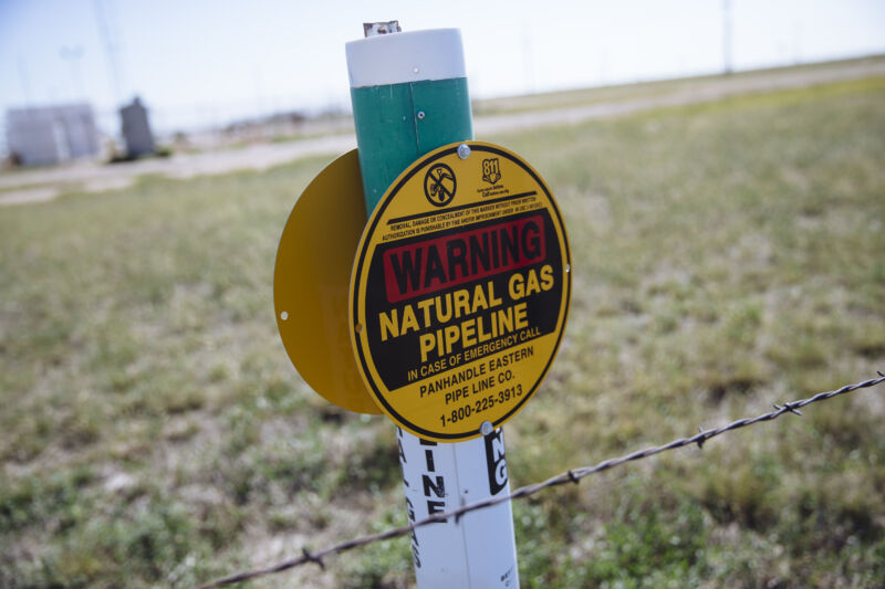 A warning sign for an underground natural gas pipeline stands near Sunray, Texas.