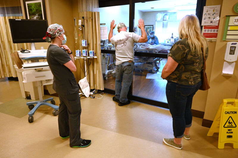 Anthony Church says goodbye through glass windows to his daughter, who is recovering from COVID-19 at Johnston Memorial Hospital's ICU on June 16, 2021, in Abingdon, Va. 