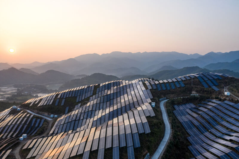 Image of a hillside covered in solar panels.