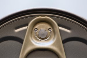 Close up of a ring pull that looks like a sloth face.