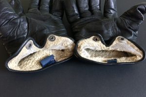 Two old leather gloves with angry faces.