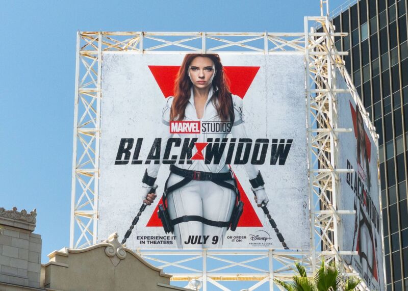 A billboard promoting the movie Black Widow with a giant picture of Scarlett Johansson.