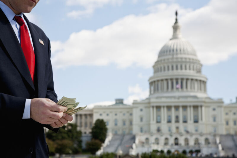 Technology A politician counting money in front of the US Capitol Building.
