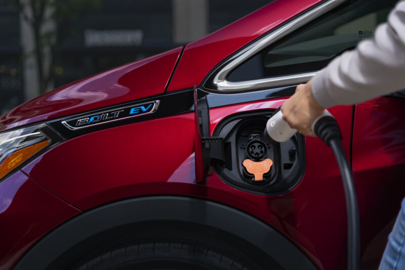 Promotional image of electric vehicle about to be charged.