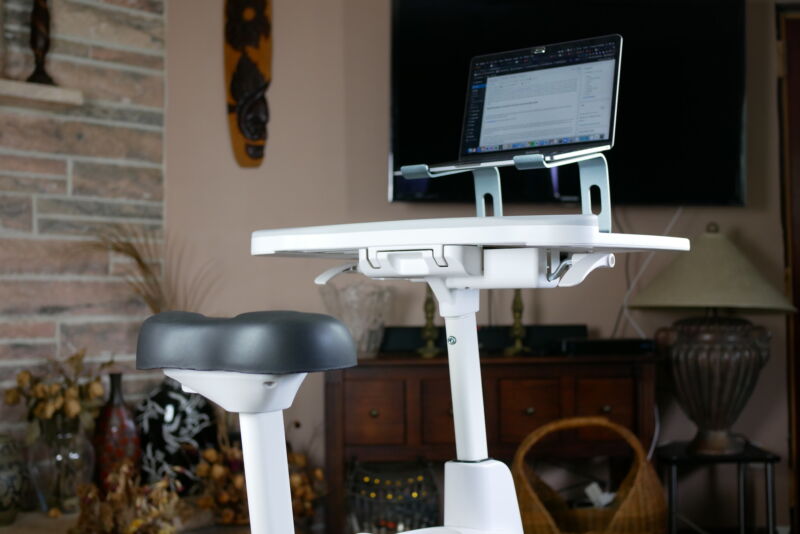 The Bike Seat And Desktop Of The Desk Bike With A Laptop And Wireless Keyboard On Top