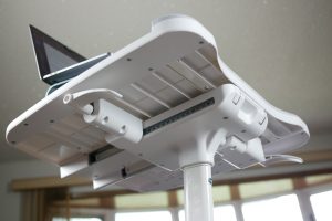 The underside of the desk bikes desktop showing levers to raise and lower the desk or slide it forward and back