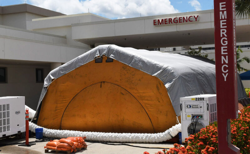 An ungainly inflatable tent has been set up next to an emergency room's automobile drop-off.