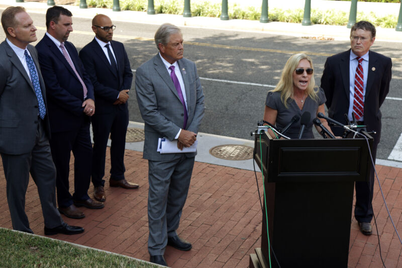 US Rep. Marjorie Taylor Greene (R-GA) speaks as Rep. Ralph Norman (R-SC) (3rd-R) and Rep. Thomas Massie (R-KY) (R) listen during a news conference outside the US Supreme Court on July 27, 2021, in Washington, DC.