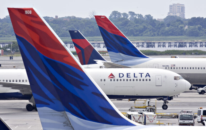 The Delta Air Lines plane heads for a gate between other Delta planes at John F. Kennedy International Airport in New York on Monday, July 20, 2009.