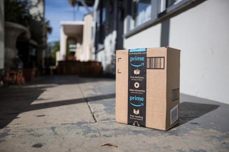 An Amazon delivery box sitting outside a door.