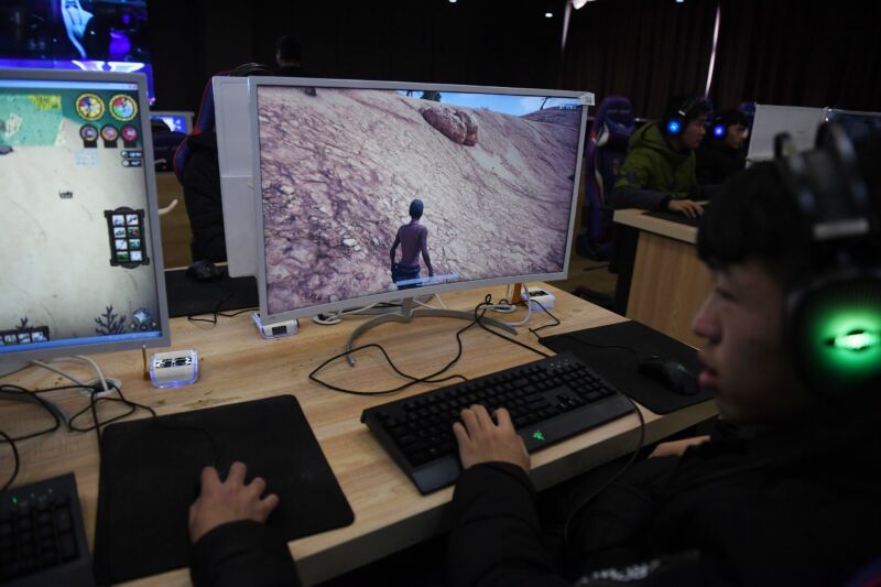 Chinese students playing video games on a computer.