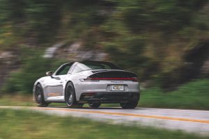 A white Porsche 911 Targa 4 GTS on a mountain road