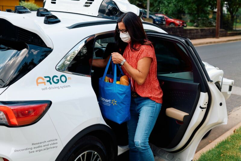 Promotional image of woman using self-driving car.