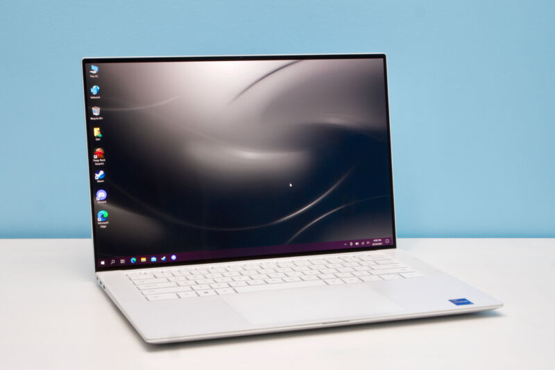 White version of the Dell XPS 15 9510 laptop sitting open on a desk.