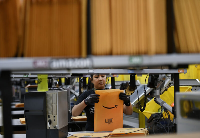 Adriana Ramirez packs items into envelopes at Amazon's Fulfillment Center on March 19, 2019, in Thornton, Colorado. The facility, which opened in July of 2018, is 855,000 square feet and employs over 1,500 people.