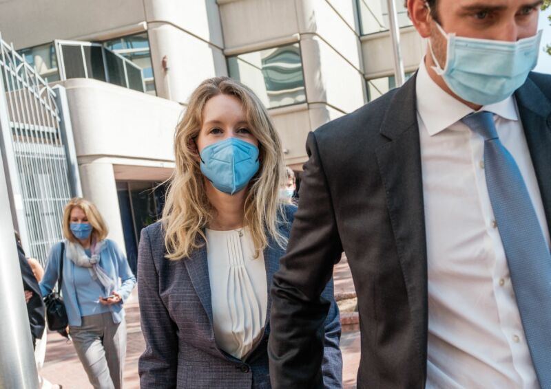 Elizabeth Holmes, founder and former CEO of blood-testing and life sciences company Theranos, leaves the courthouse with her husband Billy Evans after the first day of her fraud trial in San Jose, California, on September 8, 2021.