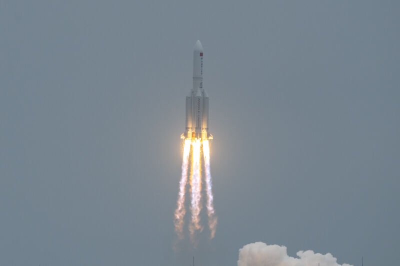 An Ascending Rocket Leaves Flame And Smoke In Its Wake.