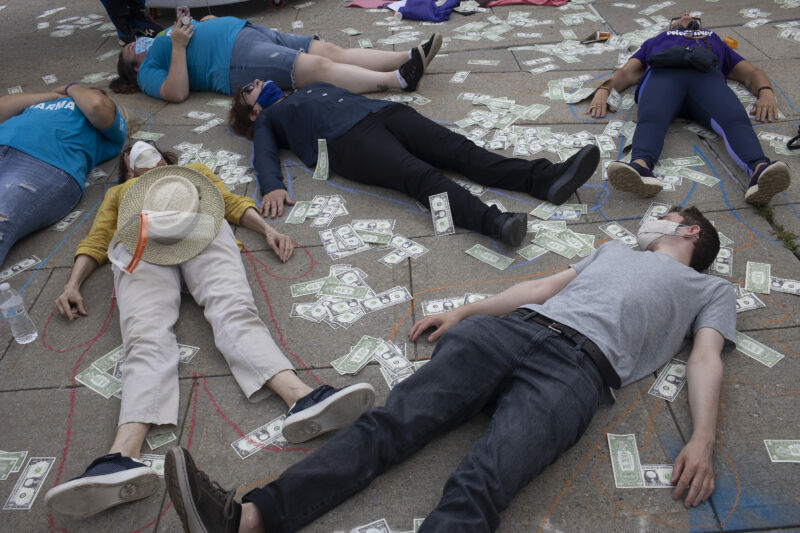 Friends and family members of people who have died during the opioid epidemic protest against a bankruptcy deal with Purdue Pharmaceuticals that allows the Sackler family to avoid criminal prosecution and to keep billions of dollars in private wealth, on August 9, 2021, outside the Federal courthouse in White Plains, New York. 