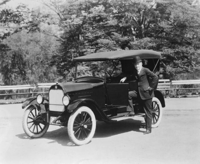 William "Billy" Durant stands proudly by the 1922 Durant Star, a direct competitor to the Model T.