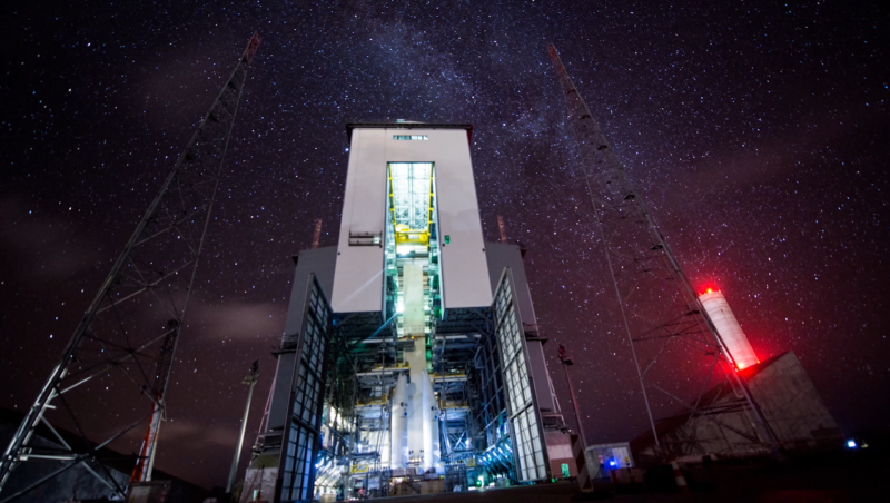 Night time at a giant rocket hanger.