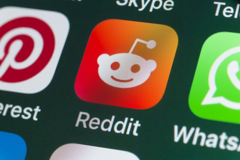 The Reddit app icon on an iPhone screen.