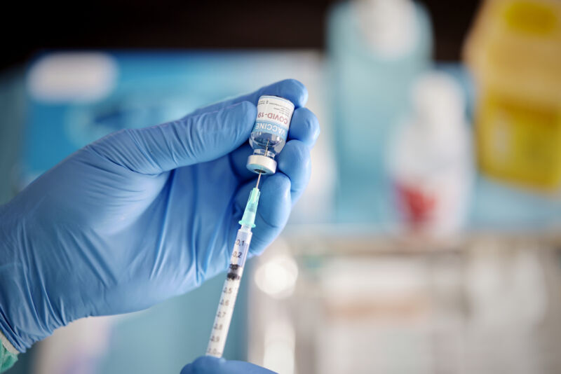 A healthcare worker preparing a COVID-19 vaccine.