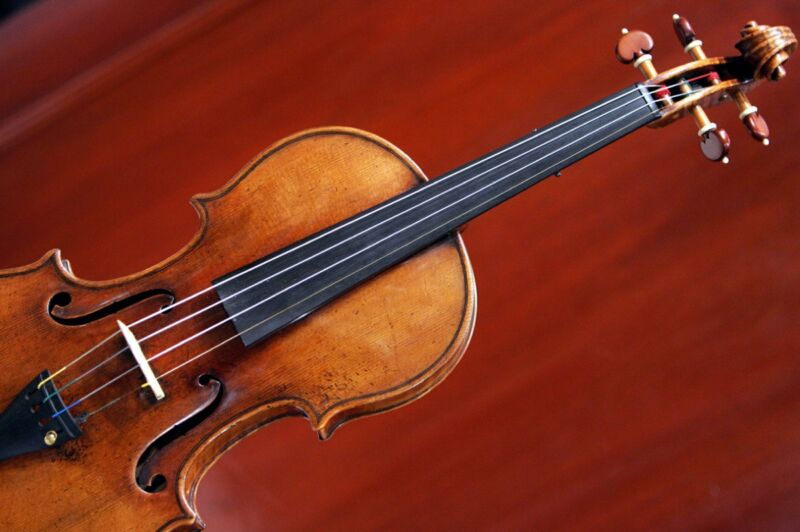 Violin against a red background.