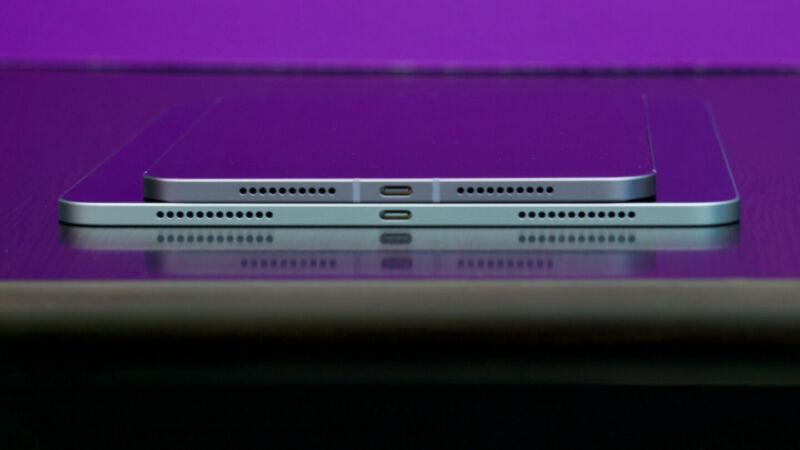 Extreme close-up photograph of the ports on the sides of stacked smartphones.