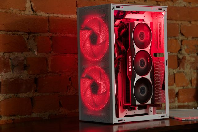 A custom-built desktop PC with red LEDs sitting on a desk.