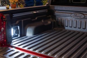 A Ford Maverick truck bed with integrated AC power and bed lights