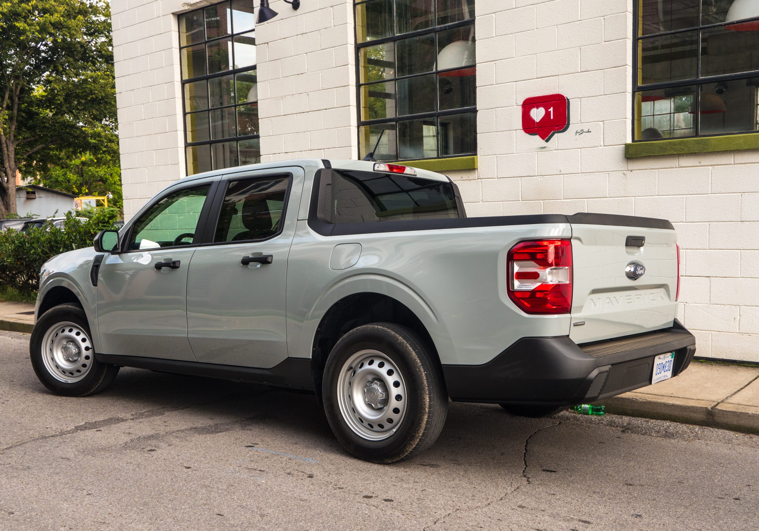 A Ford Maverick truck parked next to a mural