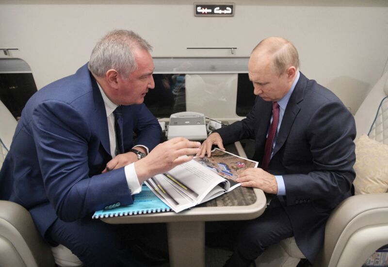 Russian President Vladimir Putin speaks with head of Russian space agency Roscosmos Dmitry Rogozin during a flight to the Vostochny cosmodrome, on September 4, 2021.