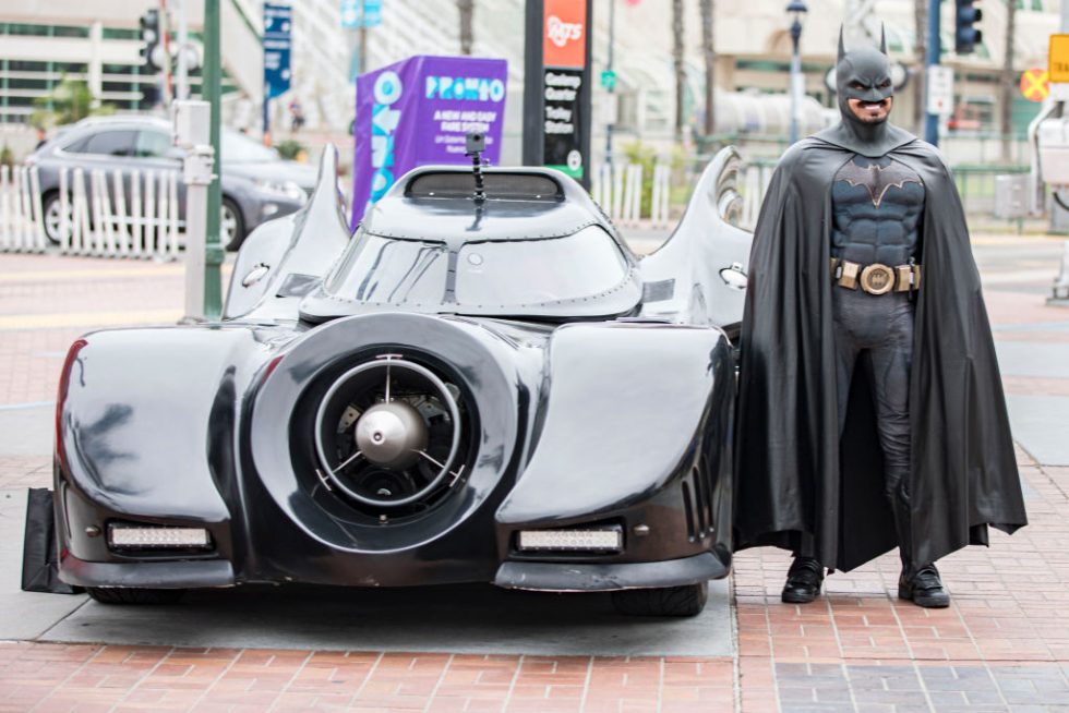 This guy isn't actually Batman, either, but he's a lot closer to being Batman than we are. (This is cosplayer Auri Aminpour next to his Batmobile. Wicked!)