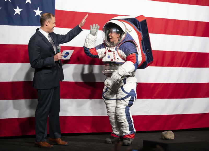 NASA Administrator Jim Bridenstine high-fives Kristine Davis, a spacesuit engineer at NASA’s Johnson Space Center, wearing a ground prototype of NASA’s new Exploration Extravehicular Mobility Unit (xEMU) in 2019.