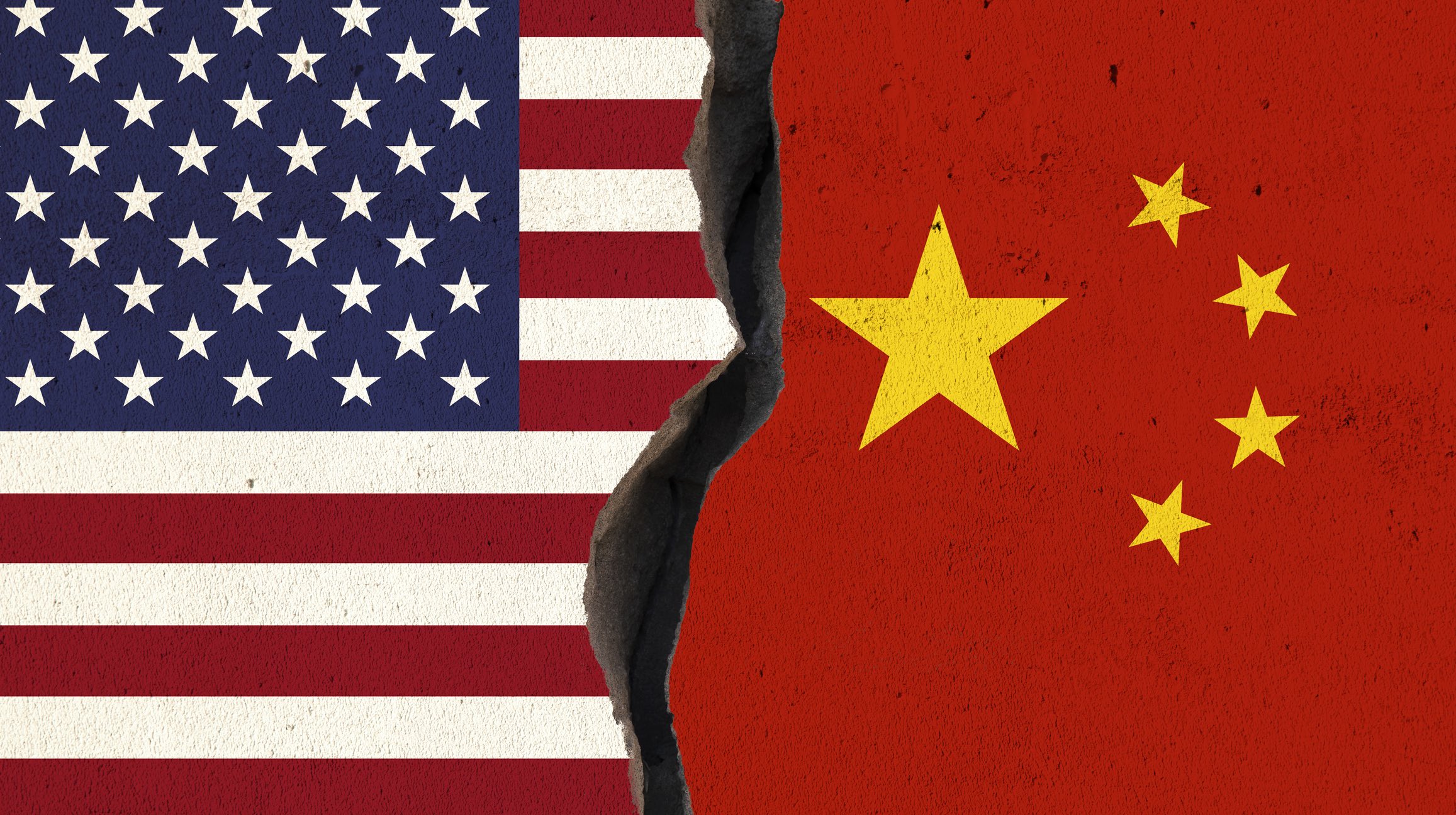 Illustration of the US and Chinese flags next to each other on a wall with a crack separating the two flags.