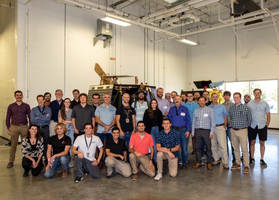 The Blue Ghost Team Is Shown In Front Of Actual-Size Spacecraft Models.