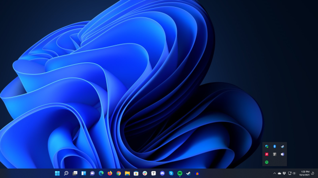 Windows' system icons can't be hidden, but third-party tray icons can still be confined to this overflow window.