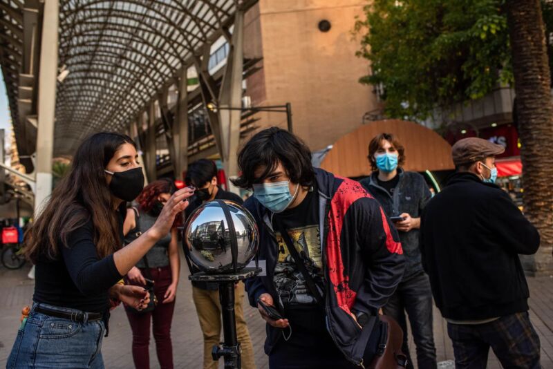 People in Chile with Worldcoin's "Orb" iris scanner.