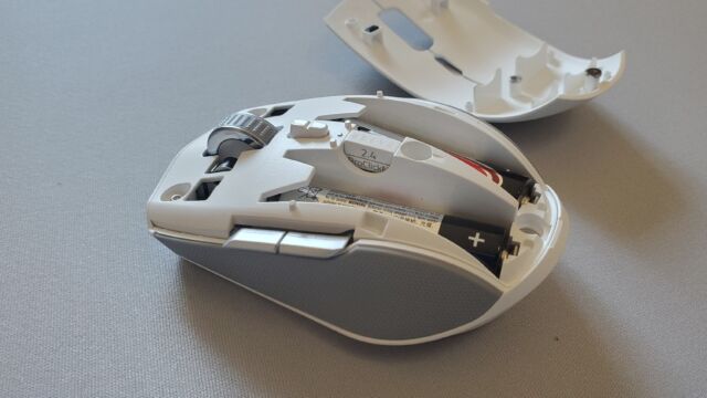 Opening the mouse reveals spots for two AA batteries and the dongle.
