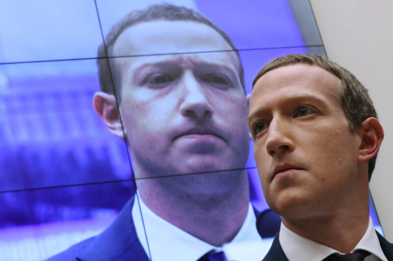 With an image of himself on a screen in the background, Facebook co-founder and CEO Mark Zuckerberg testifies before the House Financial Services Committee in the Rayburn House Office Building on Capitol Hill October 23, 2019, in Washington, DC.