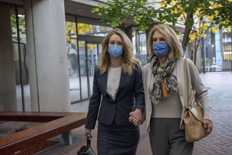 Elizabeth Holmes, founder of Theranos Inc., left, arrives at federal court in San Jose, California, on Tuesday, Nov. 2, 2021.