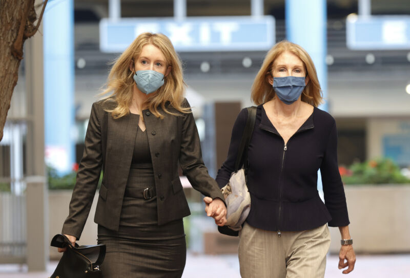 Theranos founder and former CEO Elizabeth Holmes, left, walks with her mother, Noel Holmes, as they arrive for Elizabeth Holmes' trial at the Robert F. Peckham Federal Building on November 17, 2021, in San Jose, California. Holmes is facing charges of conspiracy and wire fraud for allegedly engaging in a multimillion-dollar scheme to defraud investors.