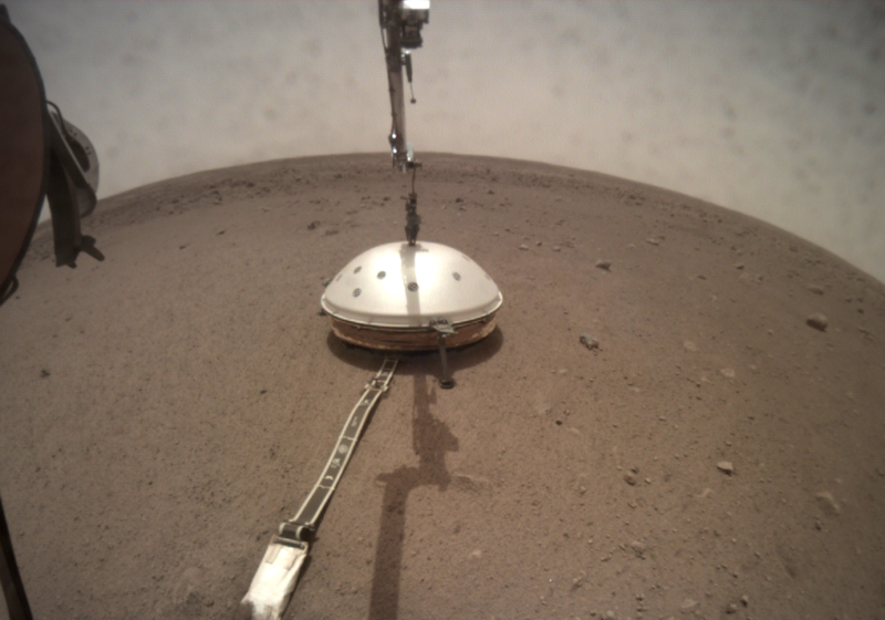 InSight places a wind shield over its seismometer.