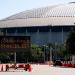 A parking lot in front of the 8th Wonder of the World (the Astrodome in Houston).