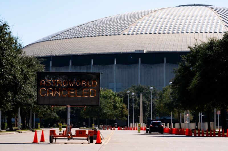 A parking lot in front of the 8th Wonder of the World (the Astrodome in Houston).