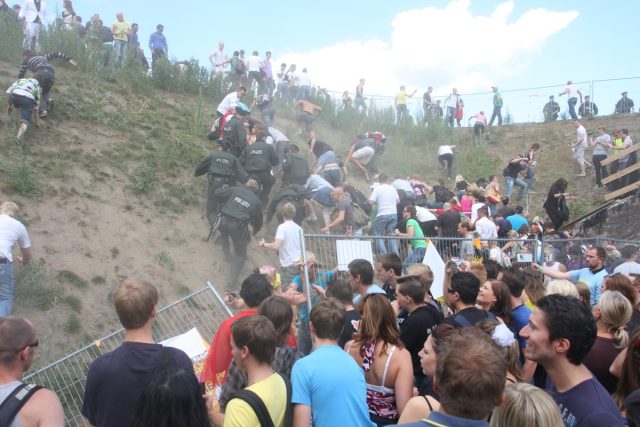 A crowd surge during the 2019 Love Parade in Germany led to 21 dead persons. Here, police try to push back people tying to escape the crush at Karl-Lehr-Street.