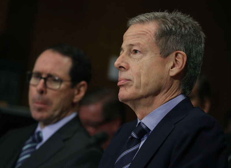 Time Warner CEO Jeff Bewkes and AT&T CEO Randall Stephenson sit and listen during a Senate Judiciary Subcommittee hearing about the AT&T/Time Warner merger.