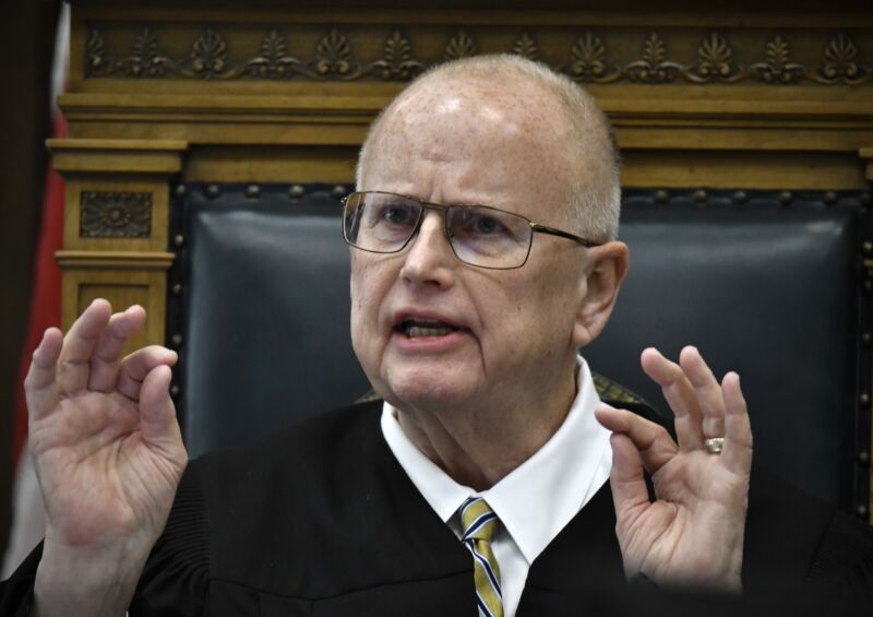 Judge Bruce Schroeder speaking from the bench and gesturing with his hands.